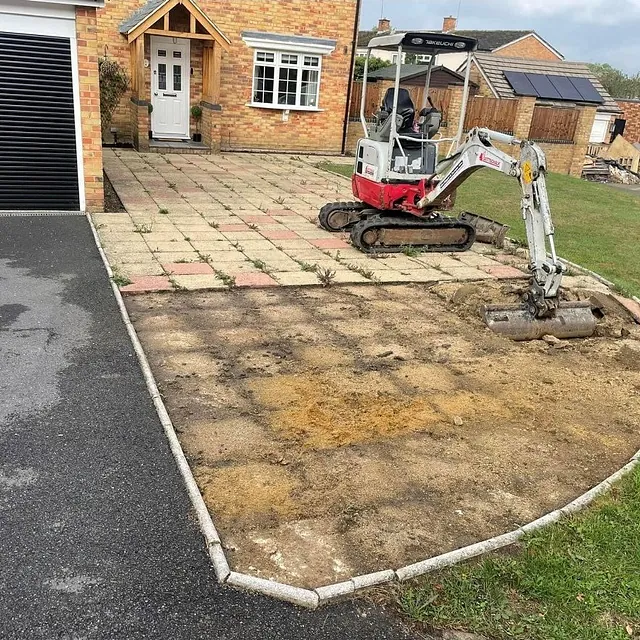 Digger digging up garden