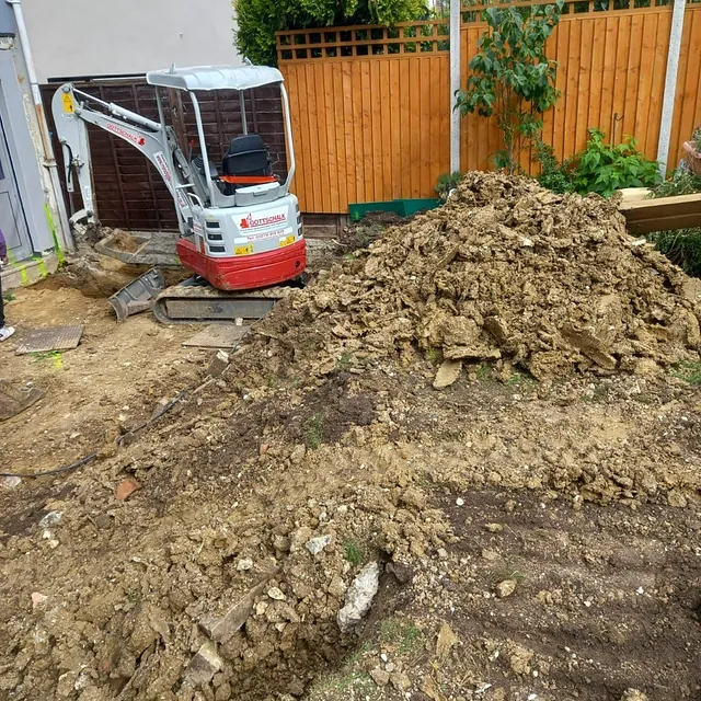 Digger with pile of rubble